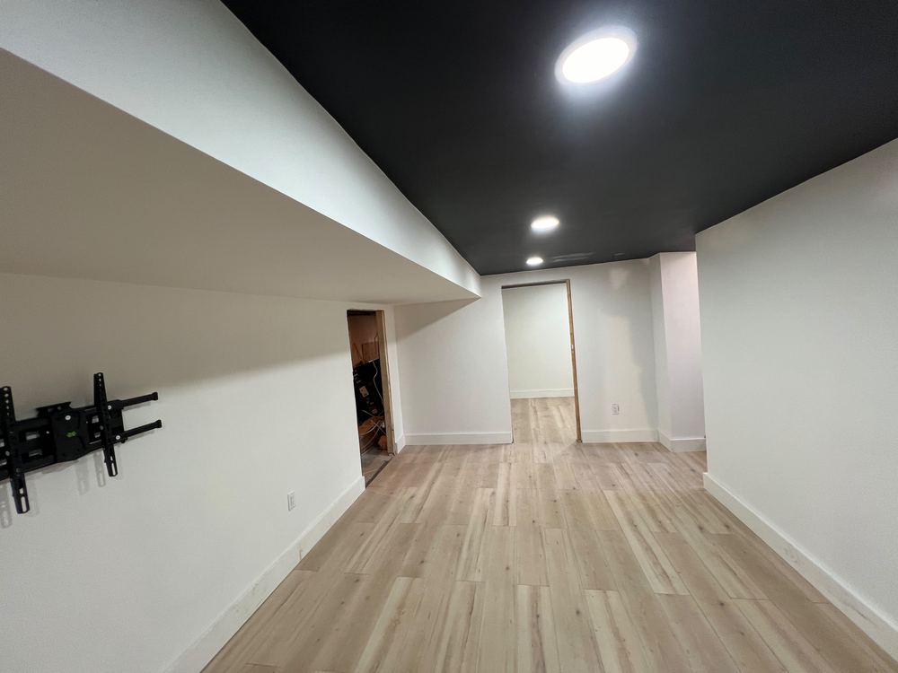 Basement with Black Ceiling and Grey Bath
